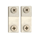 Two metallic square blocks with circular holes and star-shaped center designs on a white background