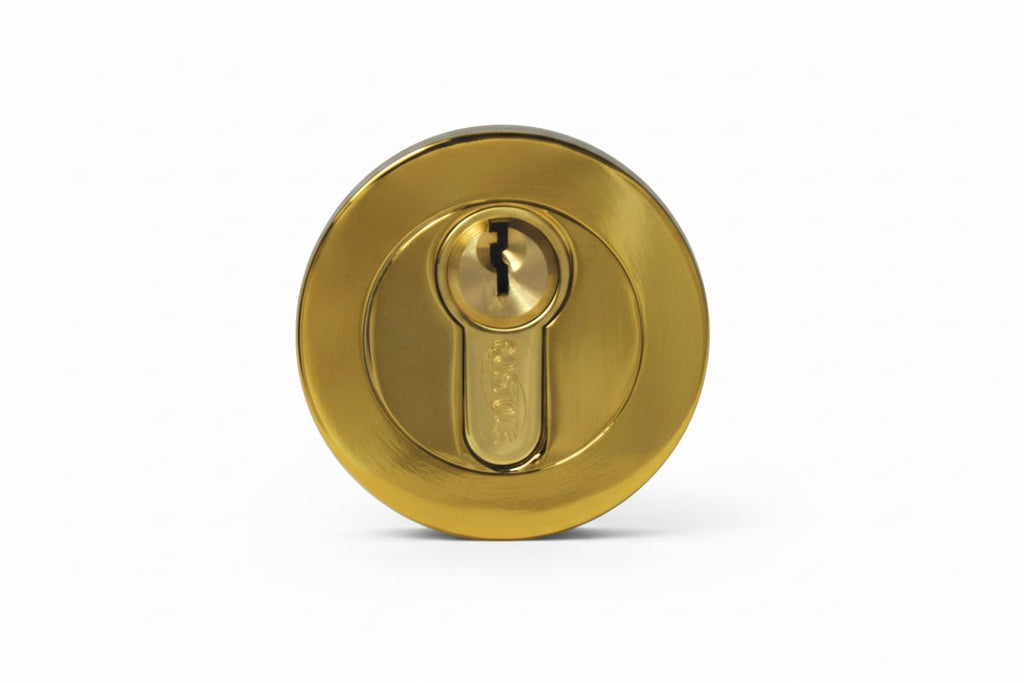 Gold cylindrical lock on a white background
