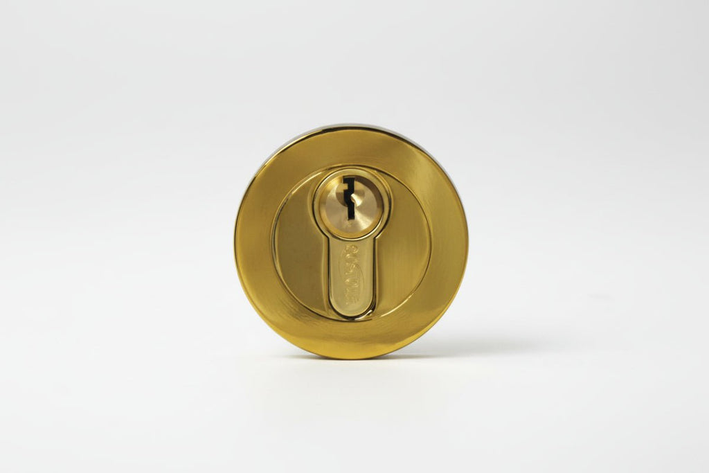 Gold door lock on a white background