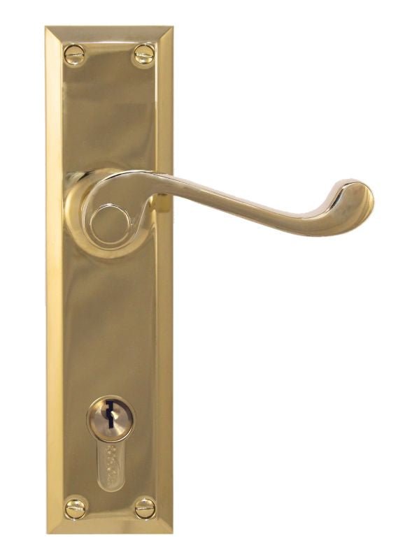 Brass door handle with lock on a white background