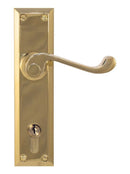 Brass door handle with lock on a white background