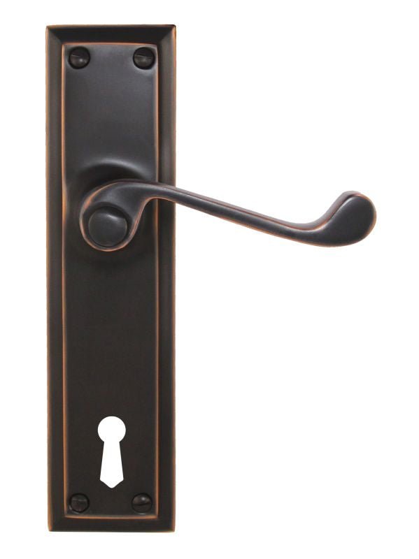 Bronze door handle with keyhole on a white background