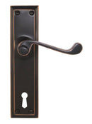 Bronze door handle with keyhole on a white background