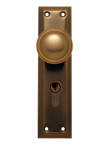 Bronze door handle with keyhole on a white background