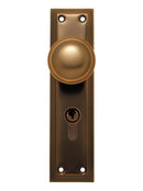 Bronze door handle with keyhole on a white background