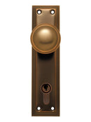 Bronze door handle with keyhole on a white background