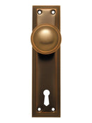 Bronze door handle with keyhole on a white background
