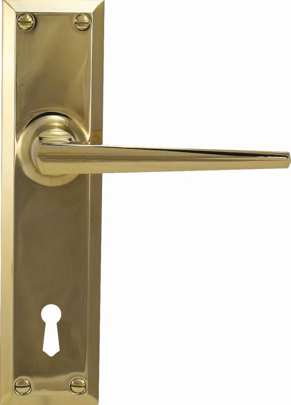 Gold door handle with keyhole on a white background