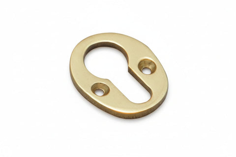 Brass oval keyhole escutcheon on a white background