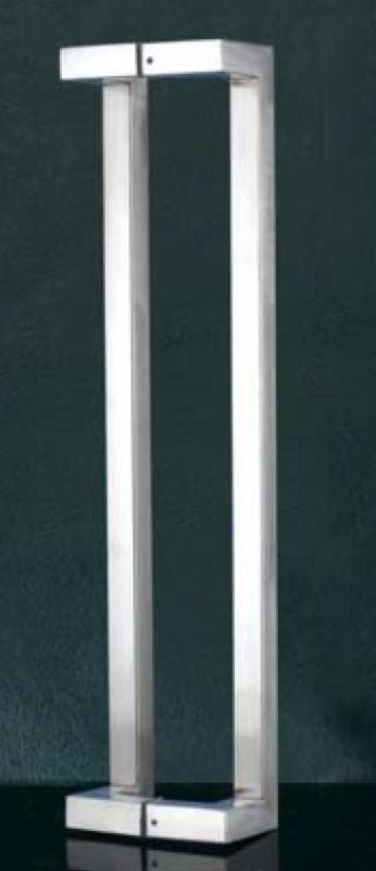 Tall, rectangular metal object with a reflective surface on a dark background