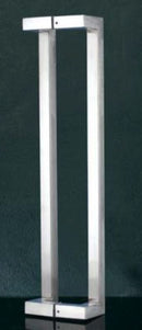 Tall, rectangular metal object with a reflective surface on a dark background
