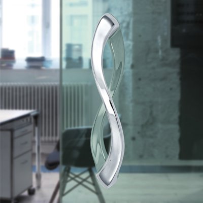 Decorative silver handle on a glass door in an office setting