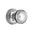 Polished chrome door knobs on a white background