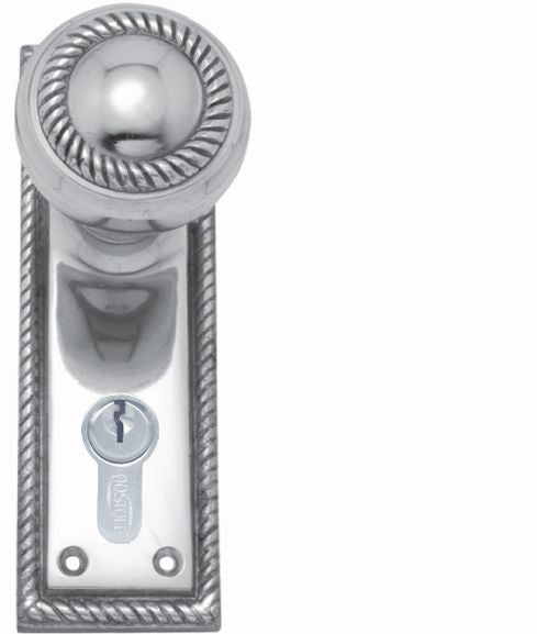 Polished chrome door handle with keyhole on a white background