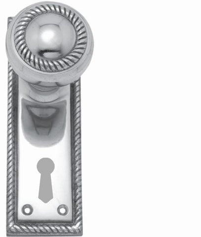 Decorative silver door handle with keyhole on a white background