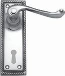 Metal door handle with decorative plate on a white background
