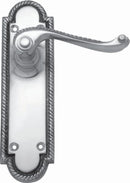 Decorative door handle with metallic finish on a white background