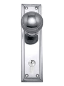 Chrome door handle and lock set on a white background