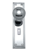 Polished chrome door handle and lock set on a white background
