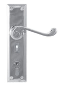 Metal door handle with keyhole on a white background