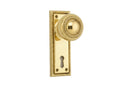 Gold door handle with keyhole on a white background