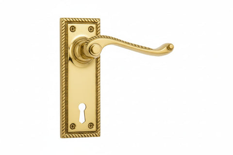 Gold door handle with keyhole on a white background