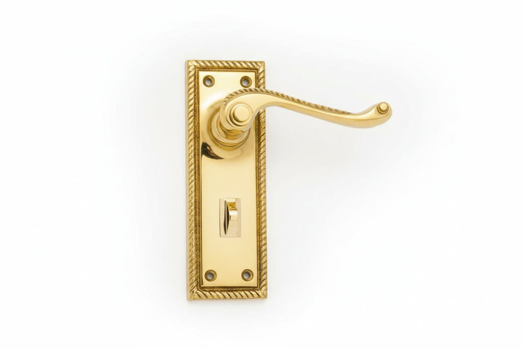 Gold door handle on a white background