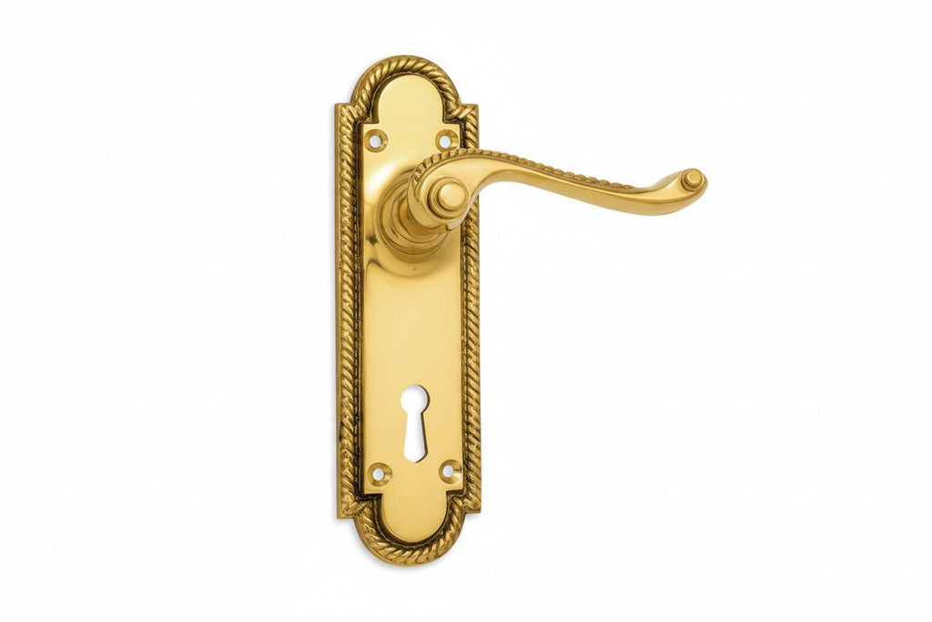Gold door handle with keyhole on a white background