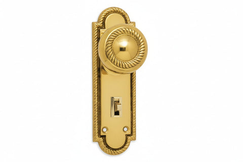 Gold door handle with keyhole on a white background