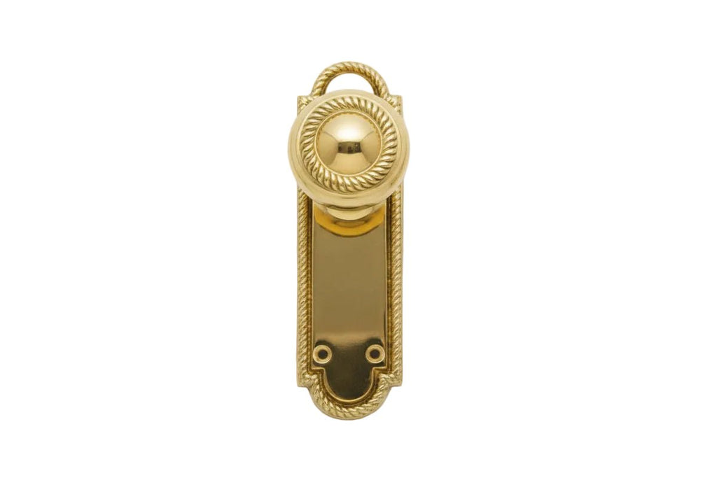 Gold door handle on a white background