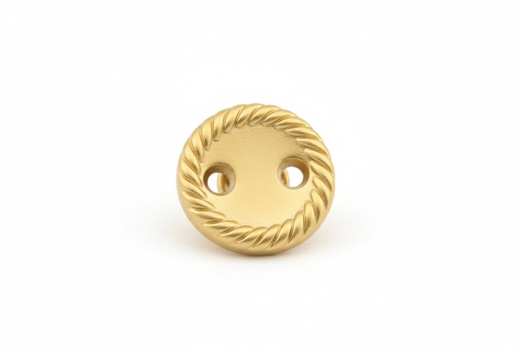 Gold button with rope pattern on a white background