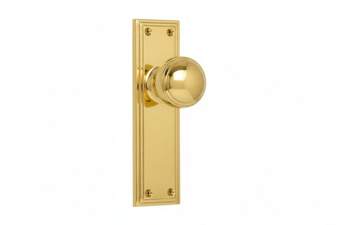 Gold door handle and plate on a white background