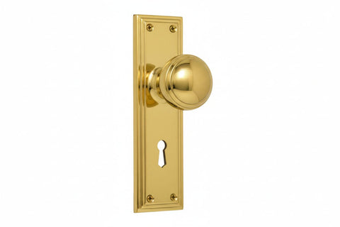 Gold door handle with keyhole on a white background