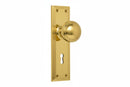 Gold door handle with keyhole on a white background