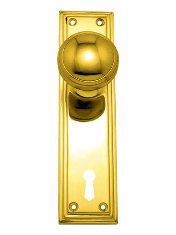 Gold door handle with keyhole on a white background