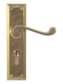 Brass door handle with lock on a white background