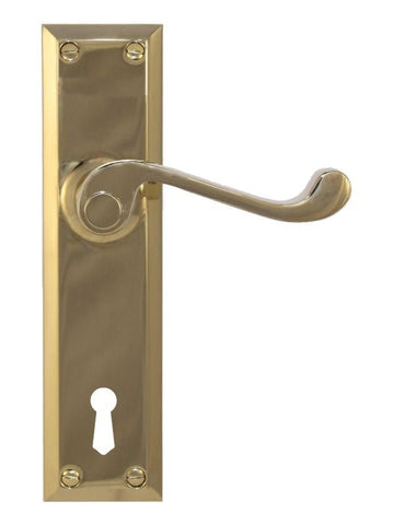 Brass door handle with keyhole on a white background