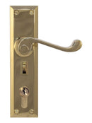 Brass door handle with lock on a white background