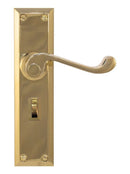Gold door handle with lock plate on a white background