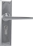 Metal door handle with lock on a white background