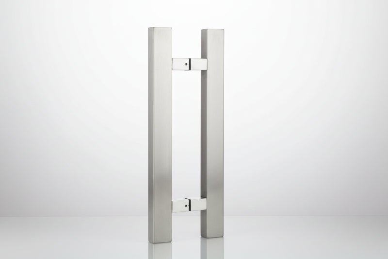 Stainless steel door handle on a dark background