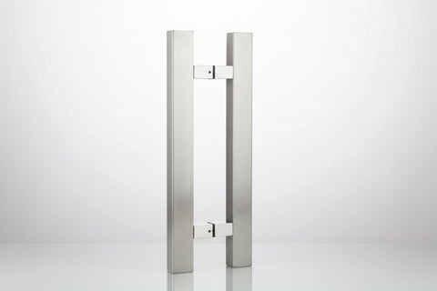 Stainless steel door handle on a dark background