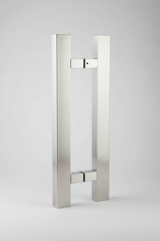Stainless steel door handle on a dark background