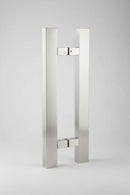 Stainless steel door handle on a dark background
