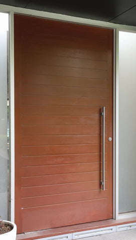 Wooden door with a handle on a building exterior