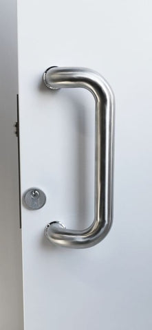 Metal door handle on a white door