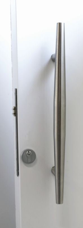 Stainless steel door handle on a white door