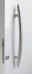 Metal door handle on a white door with a gray frame