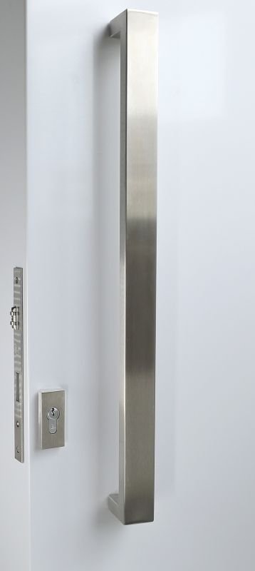 Stainless steel door handle and lock on a white door