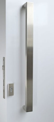 Stainless steel door handle and lock on a white door